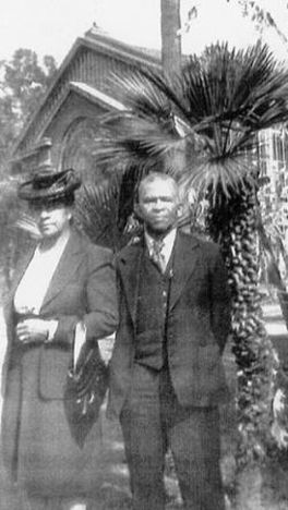 Abner Howell and his wife, Martha, in front of a palm tree