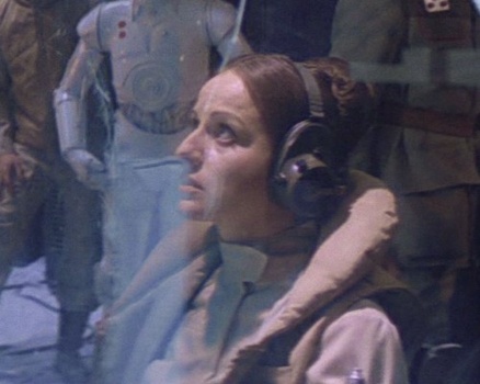 Toryn Farr at Echo Base, looking worried with a white protocol droid in the background