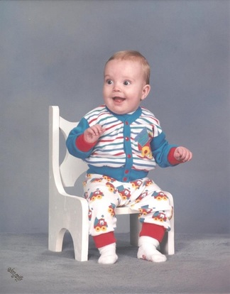 C. Randall Nicholson as a happy baby in a chair